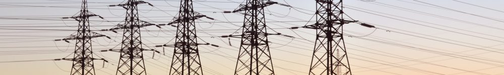 Power lines at sunset, Electric transmission line tower against blue sky